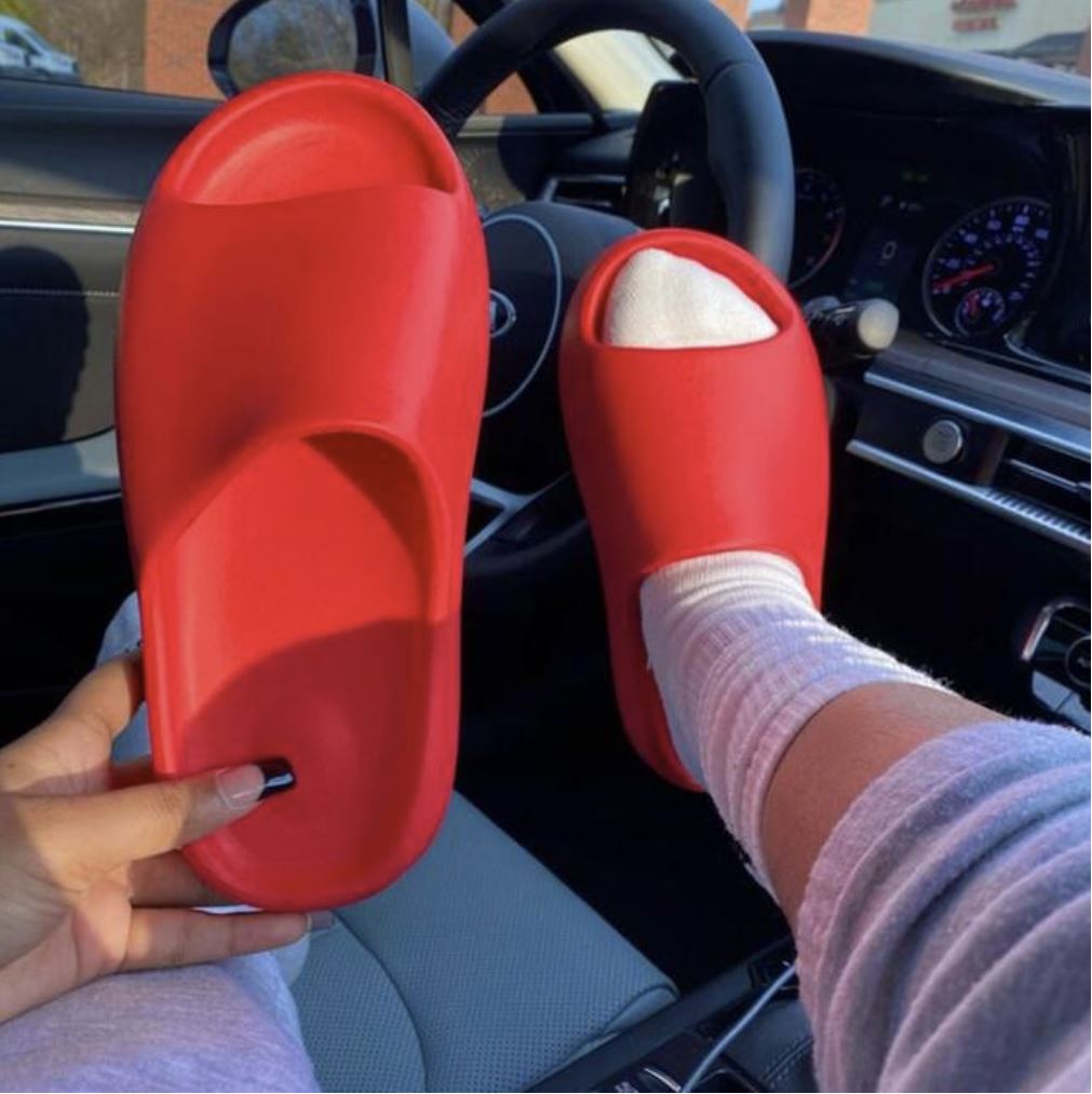 Bright red foam slide sandal lifestyle image